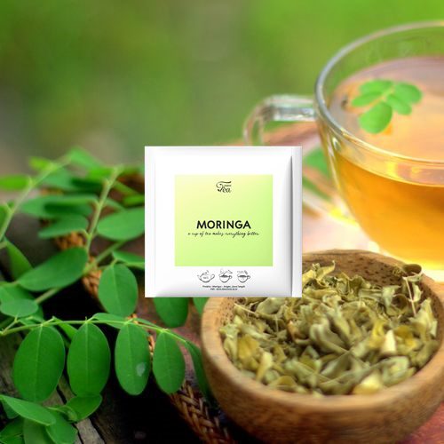 A cup of freshly brewed Moringa tea with lemon and honey on a rustic table