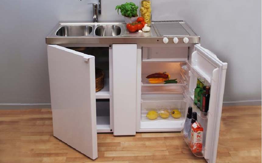 Compact tiny home kitchen with hidden cabinets