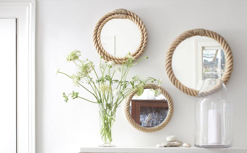 DIY boho mirror with rope frame hanging on the wall