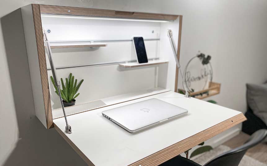 Foldable wall-mounted desk in a compact bedroom