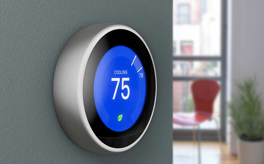 Google Nest Learning Thermostat mounted on a wall with sleek circular LED display.
