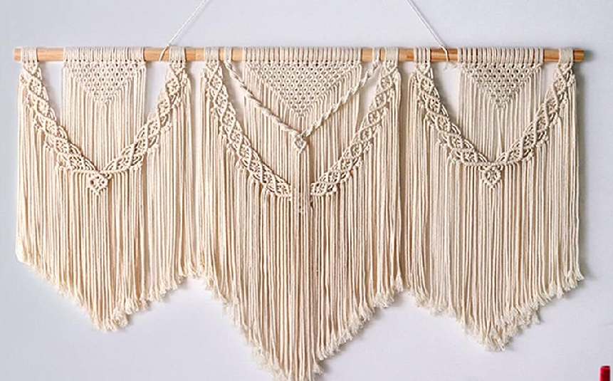 Handmade macramé wall hanging in a cozy boho living room