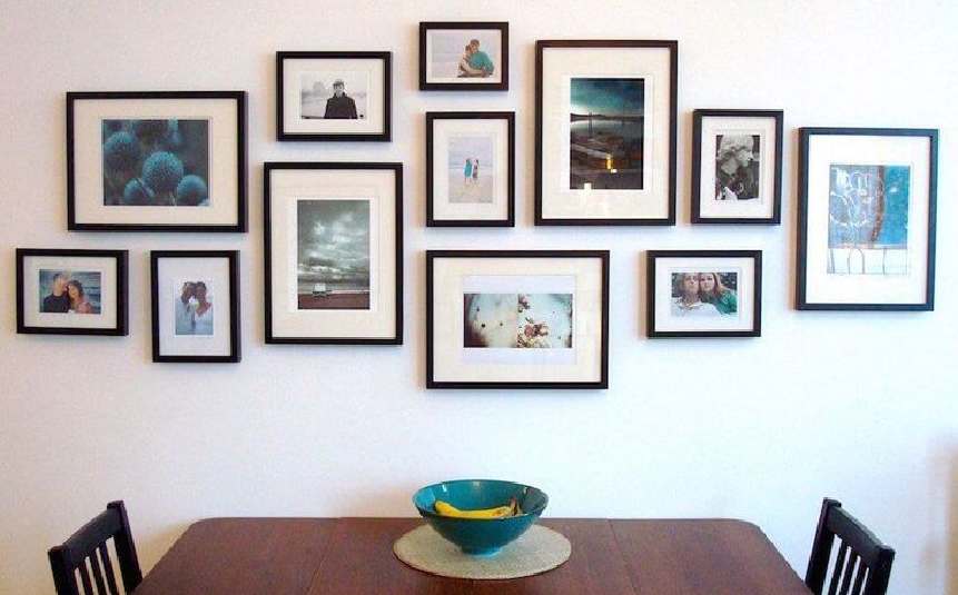 Living room with a stylish DIY gallery wall of framed art and photos
