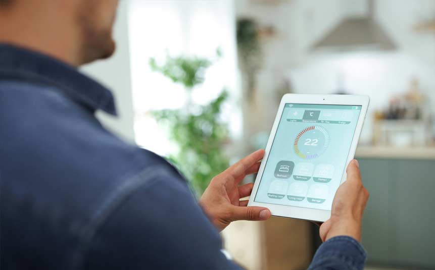 Person controlling smart thermostat temperature using a smartphone app