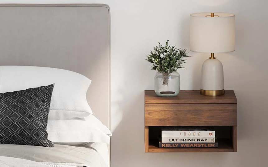 Small floating nightstand with lamp beside bed