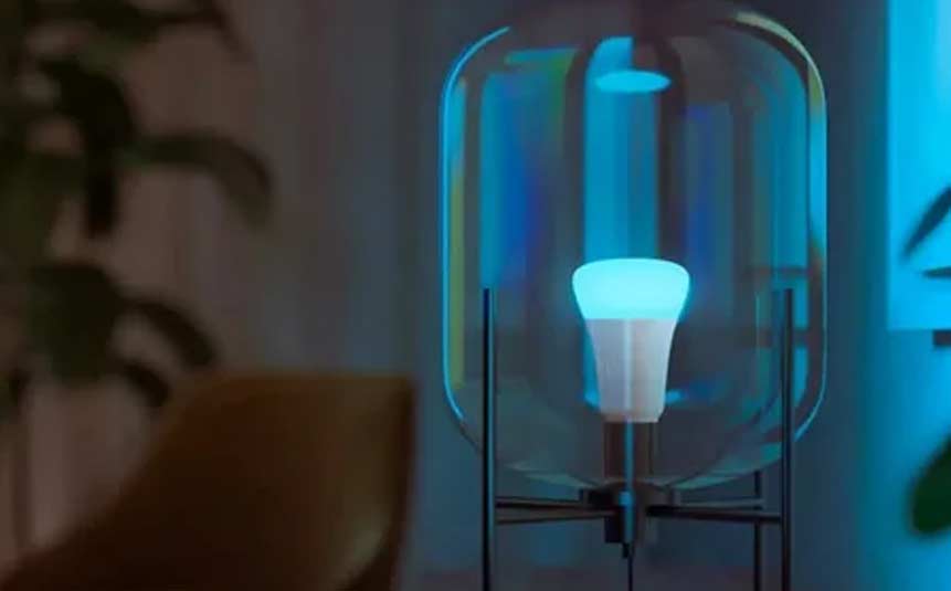 Smart bulb glowing with multiple colors inside a lamp