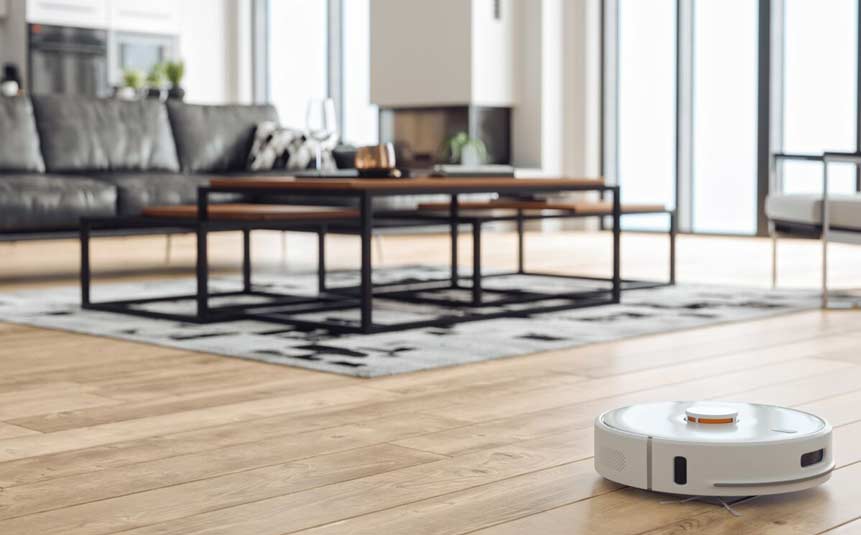 Smart robot vacuum cleaning wooden floor in living room