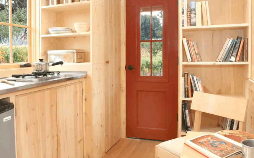 Tiny home with built-in cabinets and hidden compartments
