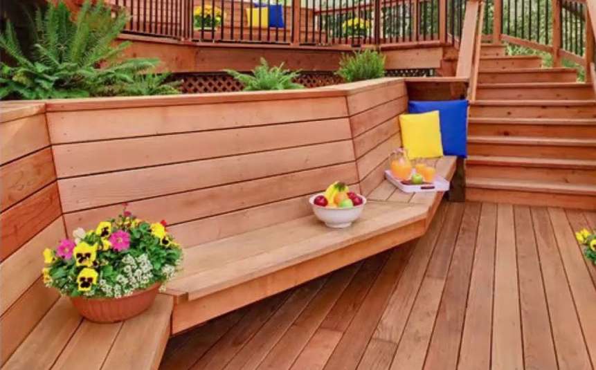 Tiny home with wooden outdoor deck and seating