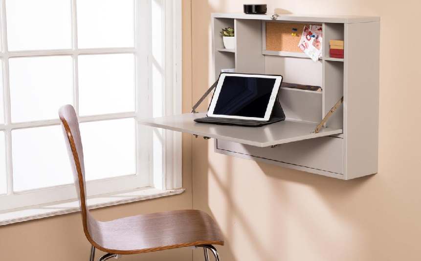 Wall-mounted fold-down desk in tiny home office corner