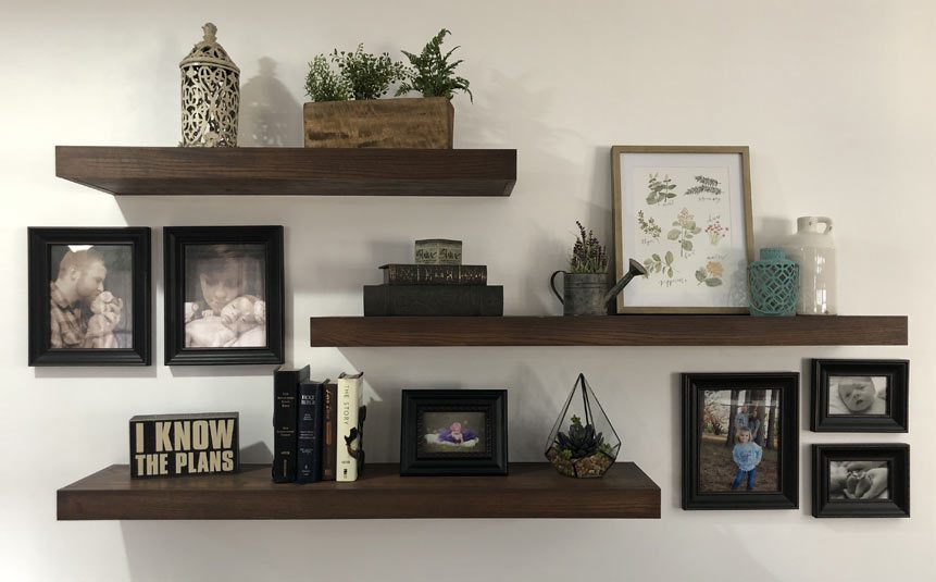 Wooden DIY floating shelves decorated with books and plants
